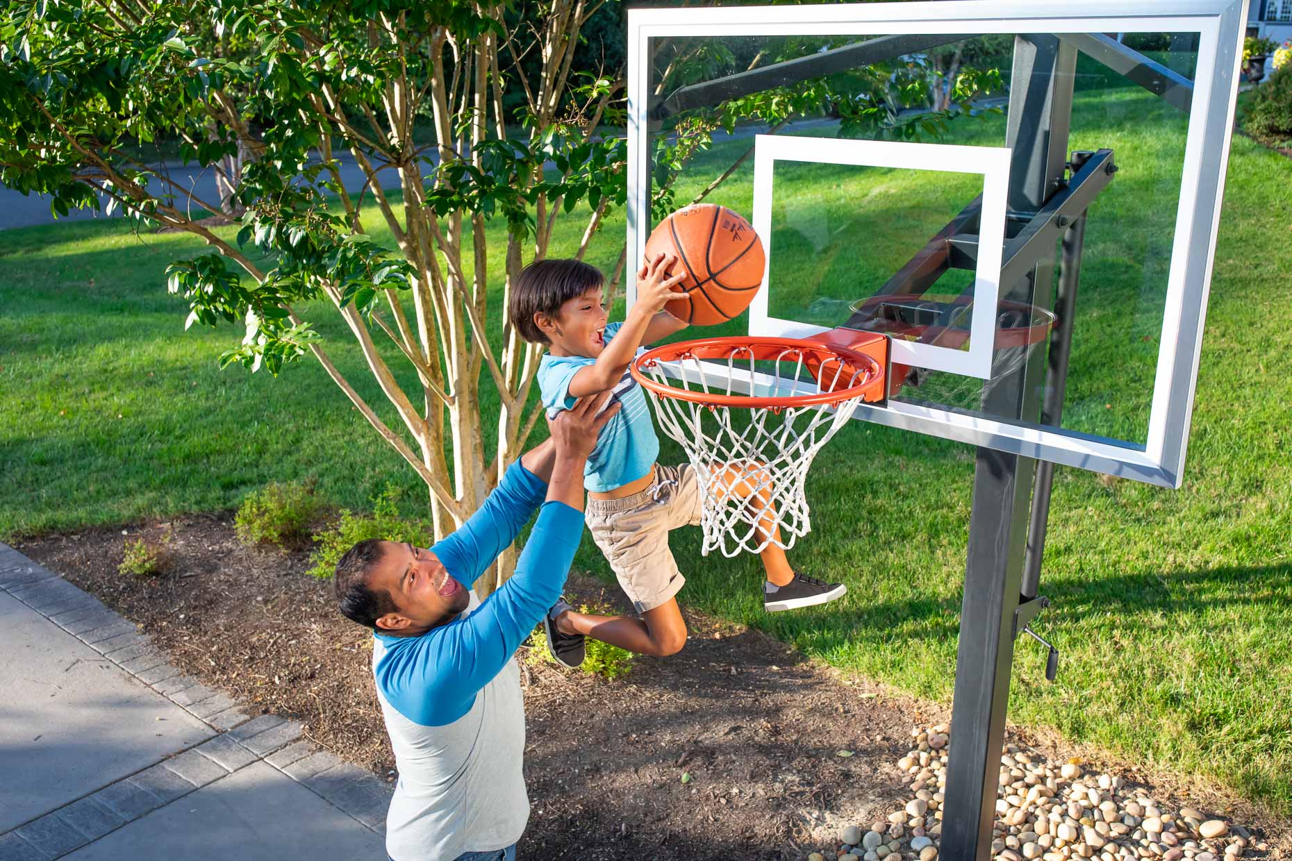 200922_Robert_Holland_father lifts son to dunk a basketball in driveway