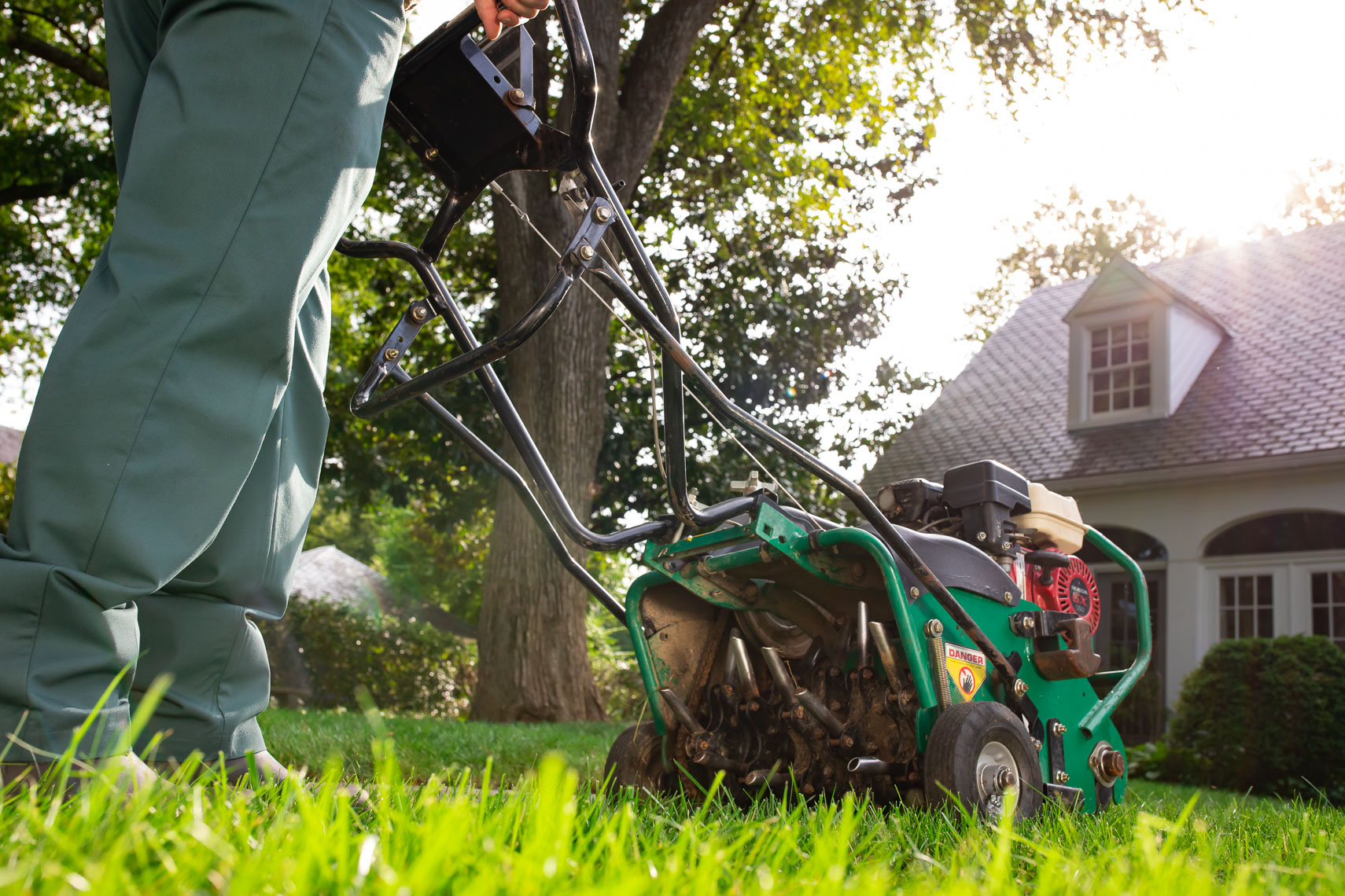 TruGreen technician aerating the lawn with a machine_Robert_Holland_Photographer_Director