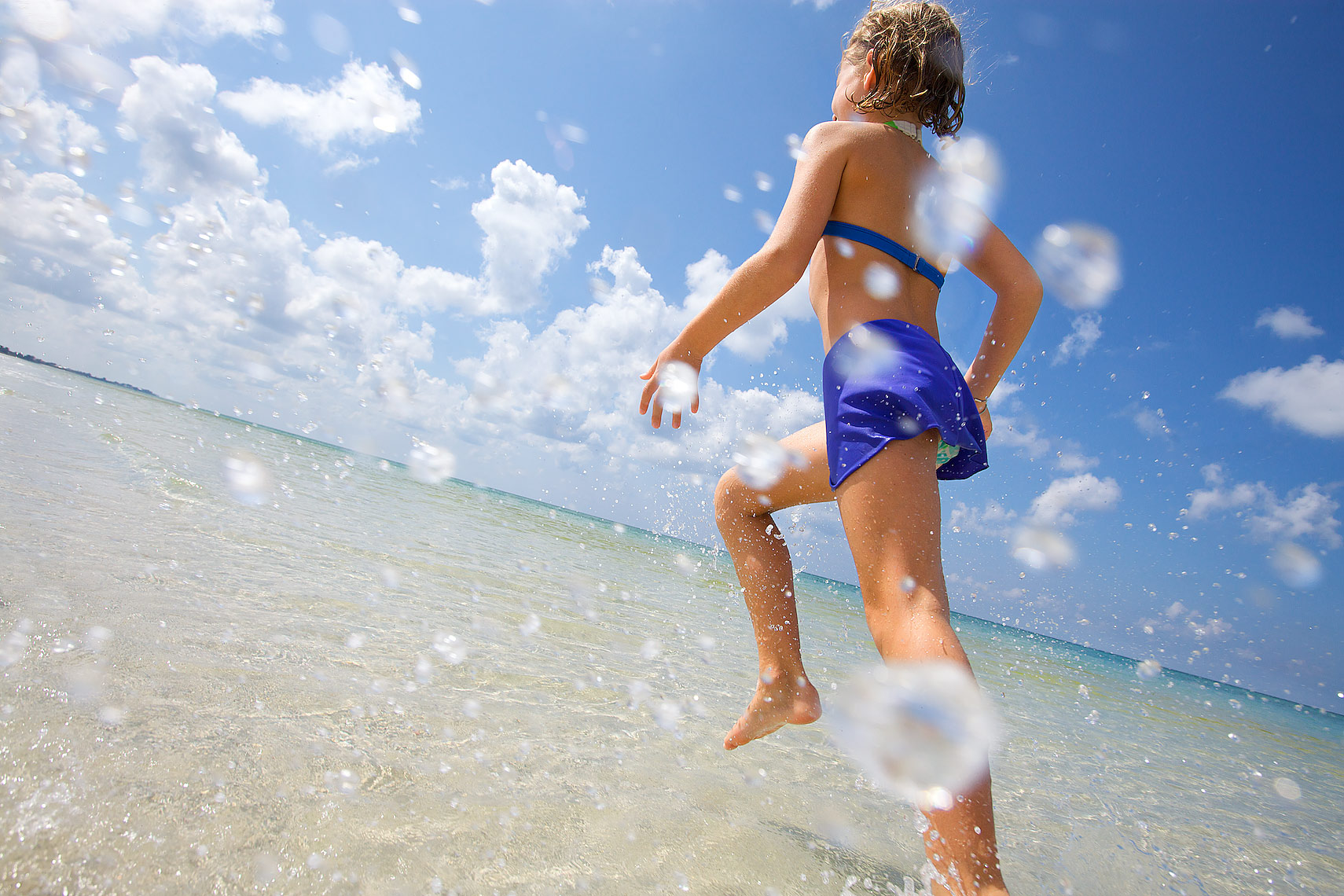 young girl runs in shallow clear splashing  water _2623_Robert-Holland.jpg