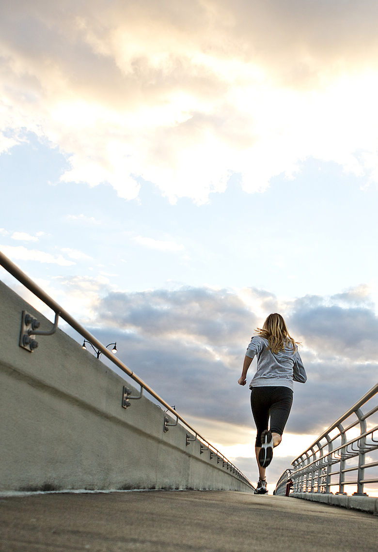 young woman runs over bridge, moody sky_Robert_Holland.jpg
