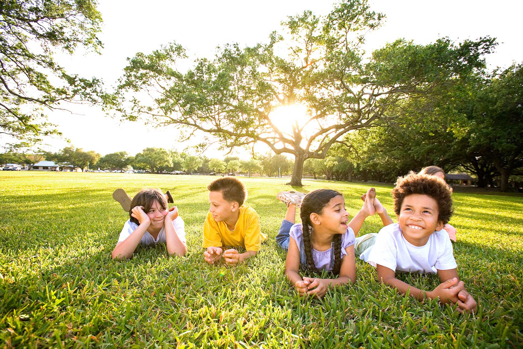 four children laying on grass hanging out at park, Florida_Robert_Holland.jpg