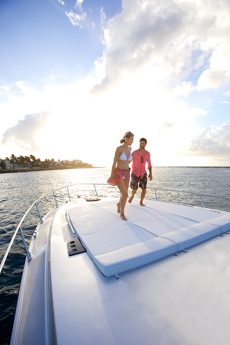 Robert-Holland_MG_2742A_couple walking on bow of sleek yacht at sunrise, Palm Beach, Florida