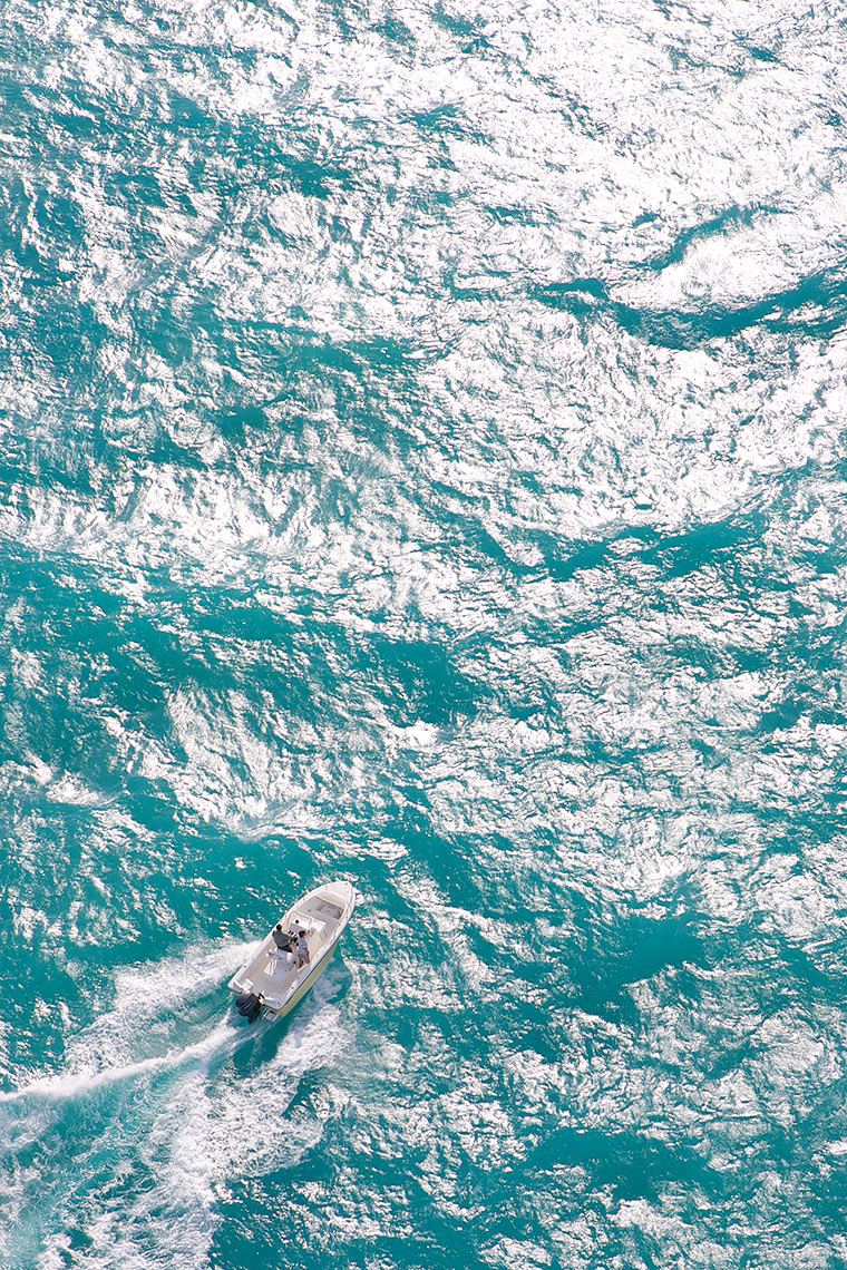 Robert Holland high altitude aerial of small boat in large offshore waves_Y0U5566-(1)