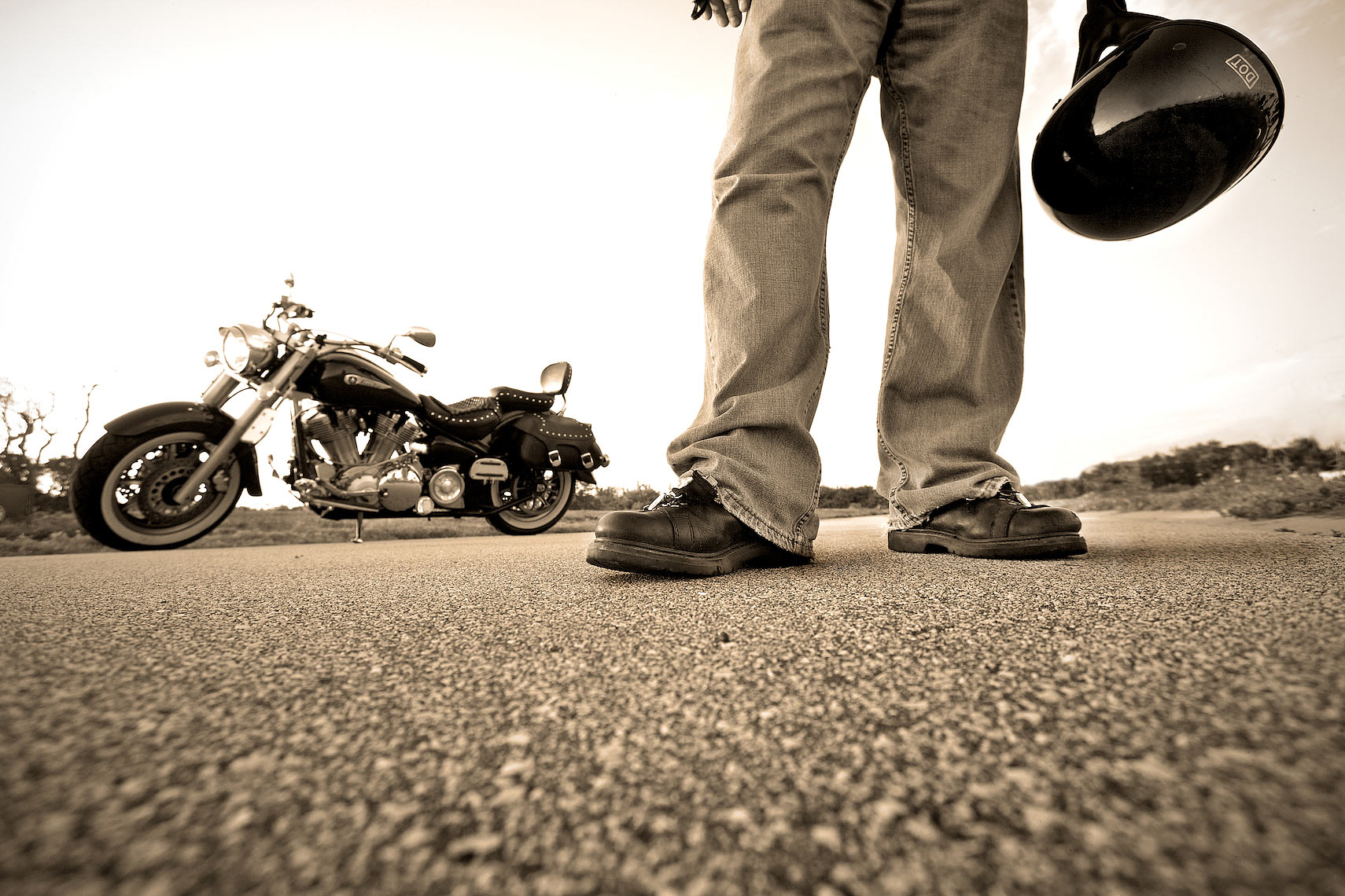 low angle view of motorcycle rider standing in road with bike_Robert-Hollan.jpg