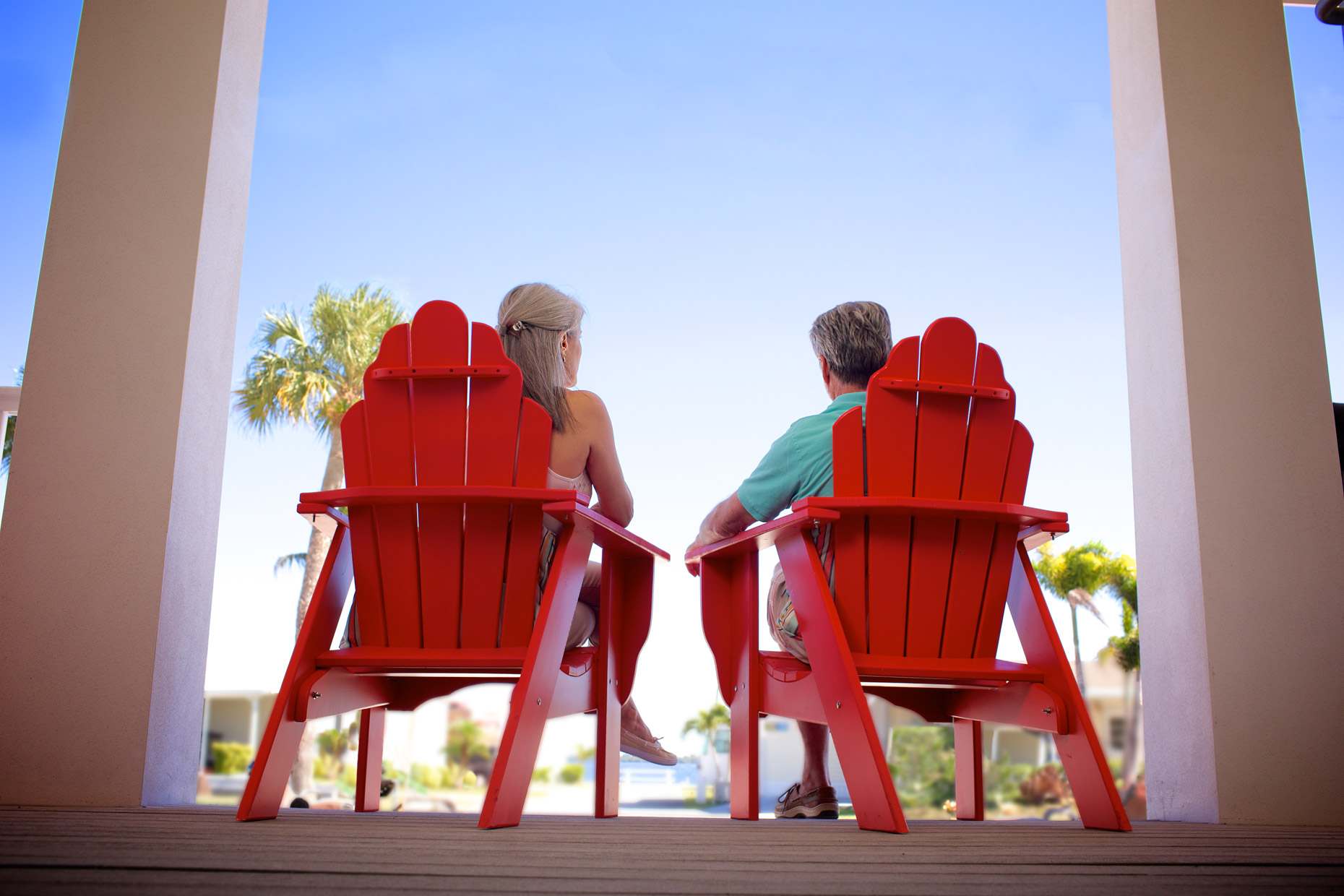 _MG_5283_RobertHolland_couple relaxing on front porch in red Adirondack chairs